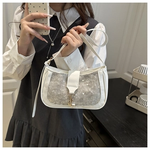Detail of white PU leather crossbody bag featuring silver sequins and lace mesh overlay