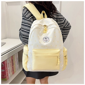 Detail of floral school backpack with star patterns and yellow contrasting straps