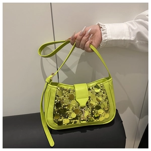Detailed shot of sequined neon green crossbody bag featuring a metallic hook buckle clasp