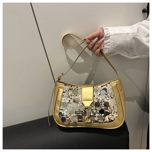 Close-up of golden sequined crossbody bag showing metallic buckle and fine strap detail