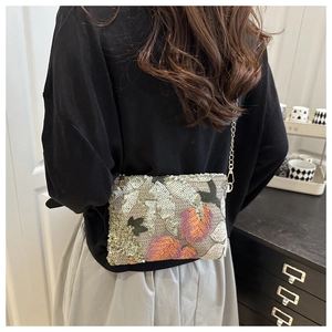 Detailed close-up of woven sequin embroidery on a rectangular bohemian envelope bag