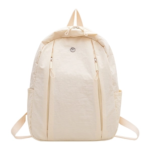 Lightweight beige nylon commute backpack with minimalist functional front zipper pockets