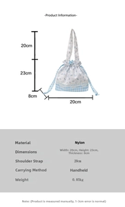 Detailed view of floral drawstring handbag showing size specs and nylon texture