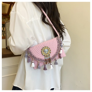 Pink bohemian woven crossbody bag featuring colorful mandala beadwork and tassels