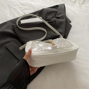 Chic white sequined shoulder bag for women with golden buckle on a black blazer