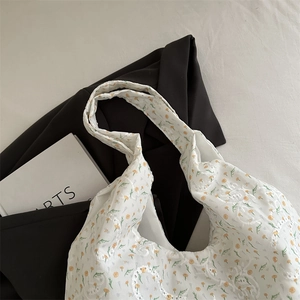 Minimalist canvas tote bag with yellow floral embroidery and white lace details