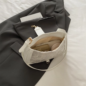 Chic white lace crossbody bag with zipper closure showing spacious internal capacity
