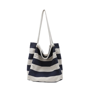 Striped canvas tote bag in navy and beige with thick woven rope handles and large capacity