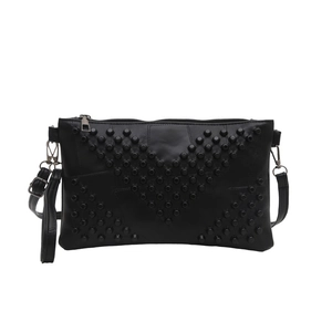 Fashionable black faux leather crossbody bag featuring stylish V-shaped rivet decorations