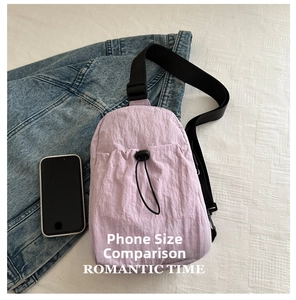Size comparison of lavender nylon chest bag with a smartphone and adjustable strap