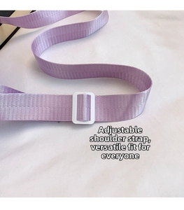 Detail of adjustable purple woven strap with white plastic buckle for messenger bag
