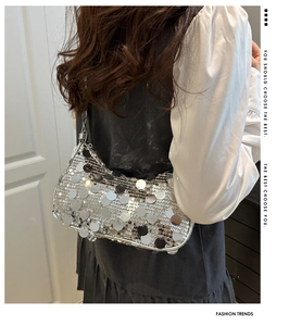 Close-up of a silver sequin underarm bag with reflective metallic Y2K party style