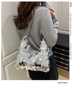 Close-up of silver sequin shoulder bag showing reflective texture and slim strap