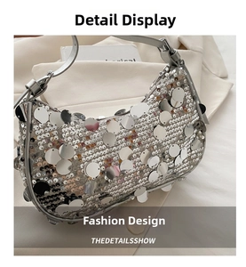 Detail view of silver hobo bag with large round sequins and metallic chain strap