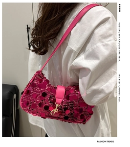 Close-up of rose red sequin crossbody bag with gold metal hook and leather strap