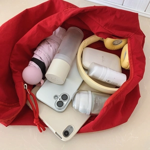 Red canvas tote bag with large capacity showing umbrella, tablet and cosmetics inside