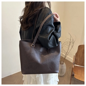 Detail of dark brown leather tote bag with FASHION & BAGS LEATHER embossing