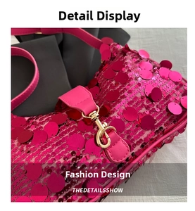 Macro detail of magenta sequin fabric with gold metal hardware and leather strap