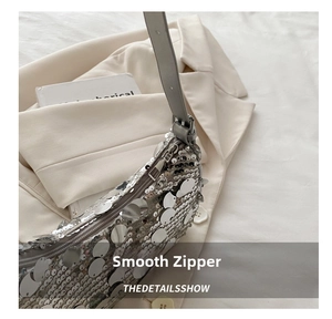 Detail showing the smooth zipper and silver sequins on the stylish shoulder bag