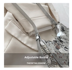 Detailed macro view of adjustable metal buckle and silver leather strap on sequin bag