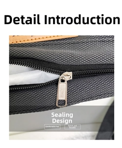 Detail view of the secure silver metal zipper closure and brown leather trim on grey tote bag