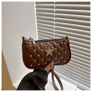 Detail of brown quilted bag featuring silver studs and a glitter star embellishment