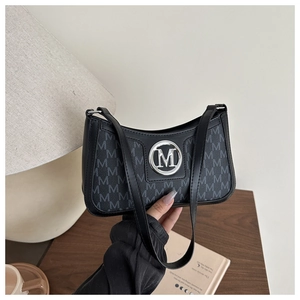 Close-up of vintage black letter print shoulder bag with silver metallic M buckle