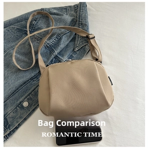 Beige nylon crossbody bag detail with wide shoulder strap and phone for size reference