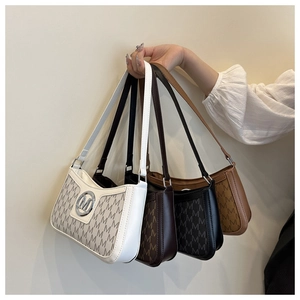 Detail view of four shoulder bags in white, coffee, black, and brown with 'M' prints