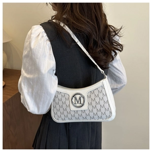 Detail of white leather shoulder bag with grey M-letter prints and silver metal buckle