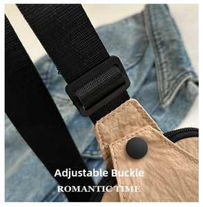 Detail of tan nylon waist bag showing black adjustable strap buckle and snap button