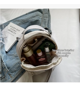 Interior view of beige nylon crossbody bag showing large storage for phone and perfume