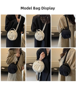 Detail view of round nylon crossbody bag with adjustable wide shoulder strap and top handle