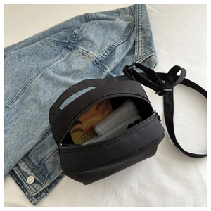 Interior view showing black crossbody bag capacity for phone and card holder