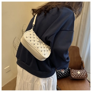 Quilted white shoulder bag with silver stars shown on model for size and style guide