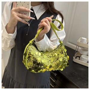 Detail of hobo bag featuring large bright yellow sequins and synthetic leather strap