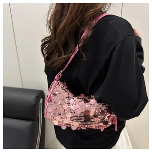 Detail shot of a pink sequin shoulder bag showing shimmering circular textures and strap