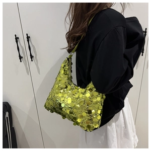 Close-up of lime green sequined hobo bag worn by model, highlighting metallic texture