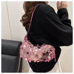 Detail of pink sequin texture on shoulder bag with reflective round paillettes