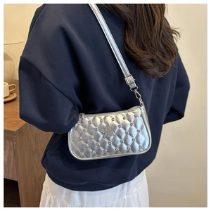 Sac à bandoulière argenté matelassé avec strass et écusson étoile porté par mannequin