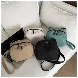 Detailed group view of four compact waterproof nylon shell crossbody bags in various colors
