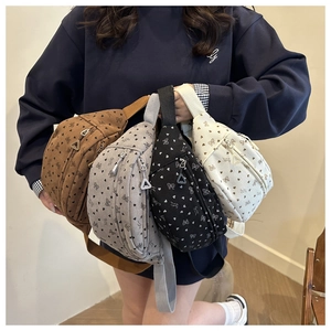 Group shot of corduroy waist bags in four colors with cute heart and bow patterns