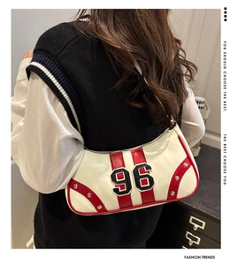 Detail view of vintage white bowling bag with red trim and number 96 embroidery