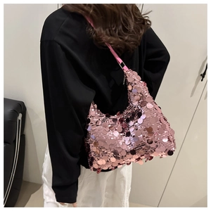 Close-up of pink sequin dumpling bag showing metallic shimmer and textured material