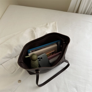 Dark brown matte leather tote bag showing spacious interior with tablet and daily essentials