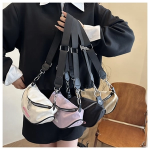 Close-up of stylish nylon dumpling bags in white, pink, black and khaki with wide straps