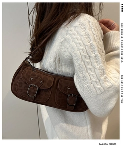 Detail of dark brown leopard print shoulder bag in faux suede with twin buckle pockets