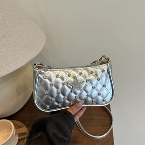 Silver quilted crossbody bag with rhinestone star detail and metallic finish