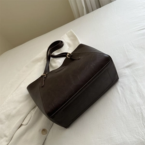 Large dark brown faux leather tote bag with adjustable straps for work or daily commute