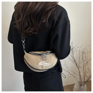 Detail of beige crescent fanny pack with logo embroidery and dual zipper closure